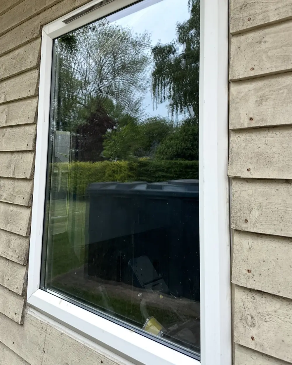 After: the same window with clear glass and a clean frame