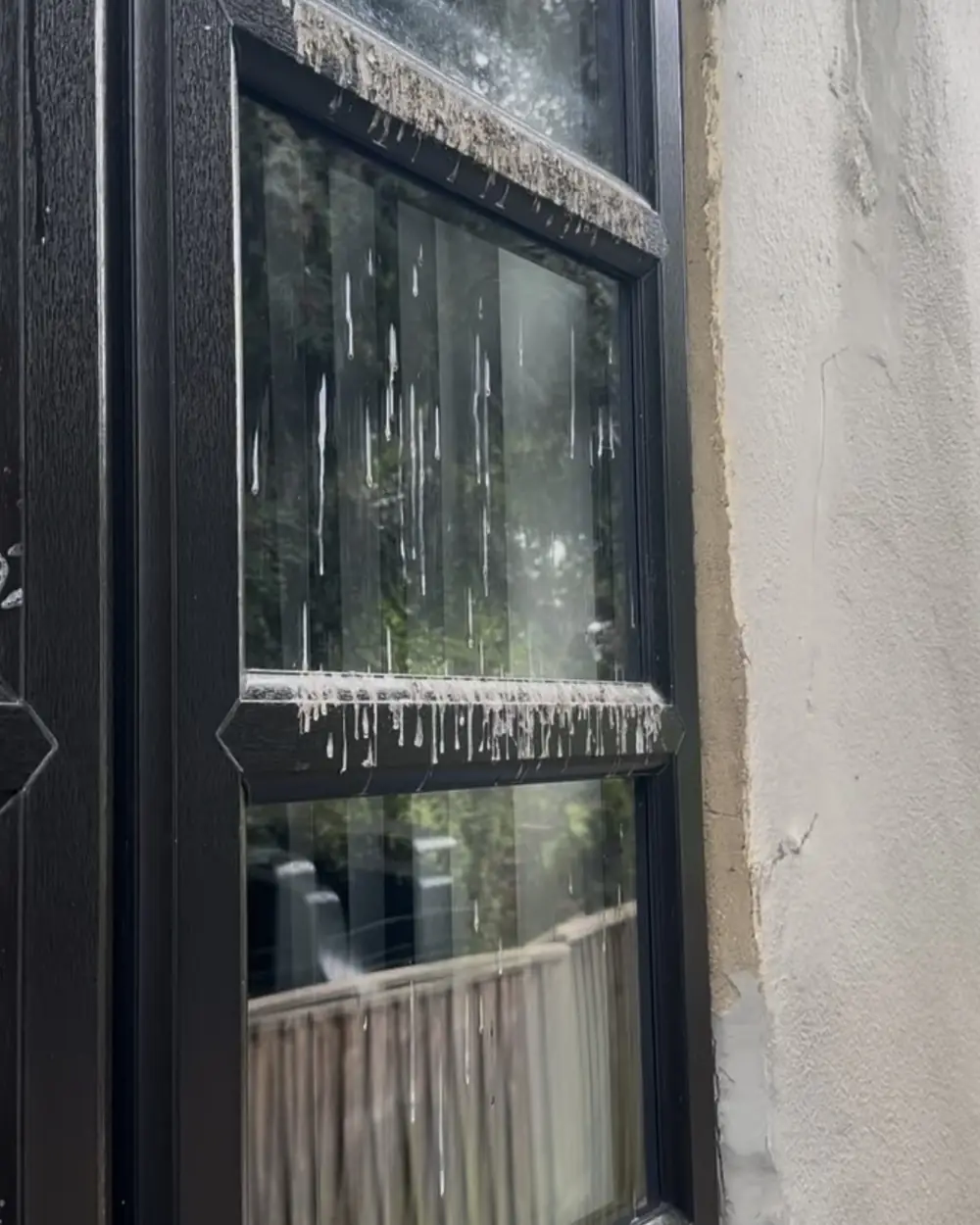 Before: a dark-framed window with dirt and white streaks running down the glass