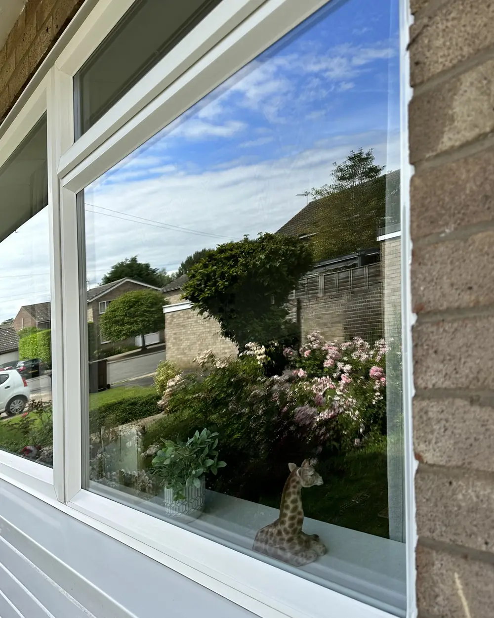 After: the same window with a clean white sill and clear glass