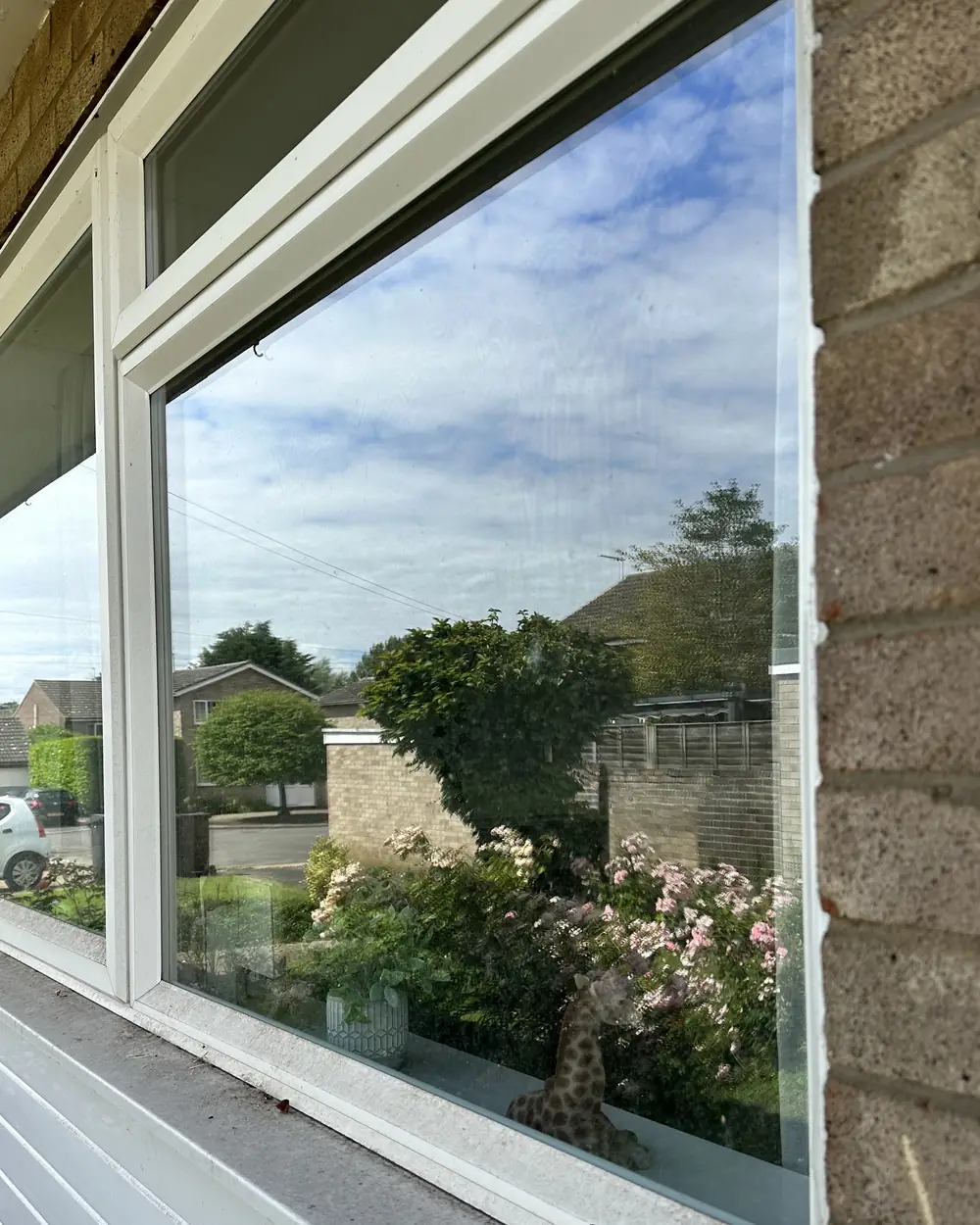 Before: a wide picture window with a grey, dusty sill